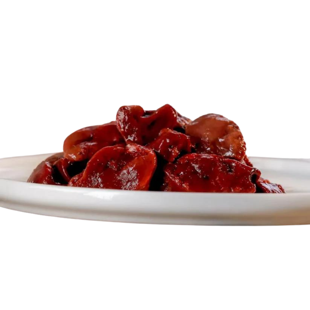 Eine weiße Schale mit rohen Hühnerleberstücken, die dunkelrot und glänzend sind. Die Leberstücke sind unregelmäßig geformt und leicht übereinander gestapelt.