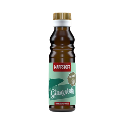 Braune Flasche mit goldfarbenem Deckel, beschriftet mit 'NAPFSTOFF Glanzstoff' und einem grünen Symbol eines Tieres. Inhalt 100 ml.