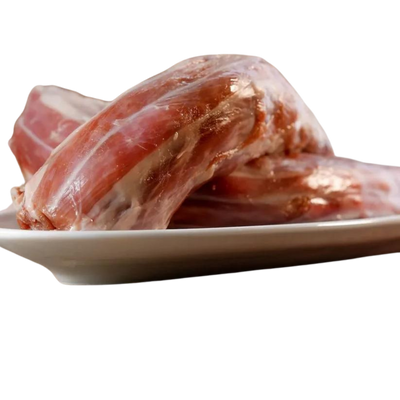 Zwei gefrorene Putenhälse auf einem weißen Teller. Marke 'Barfgold'