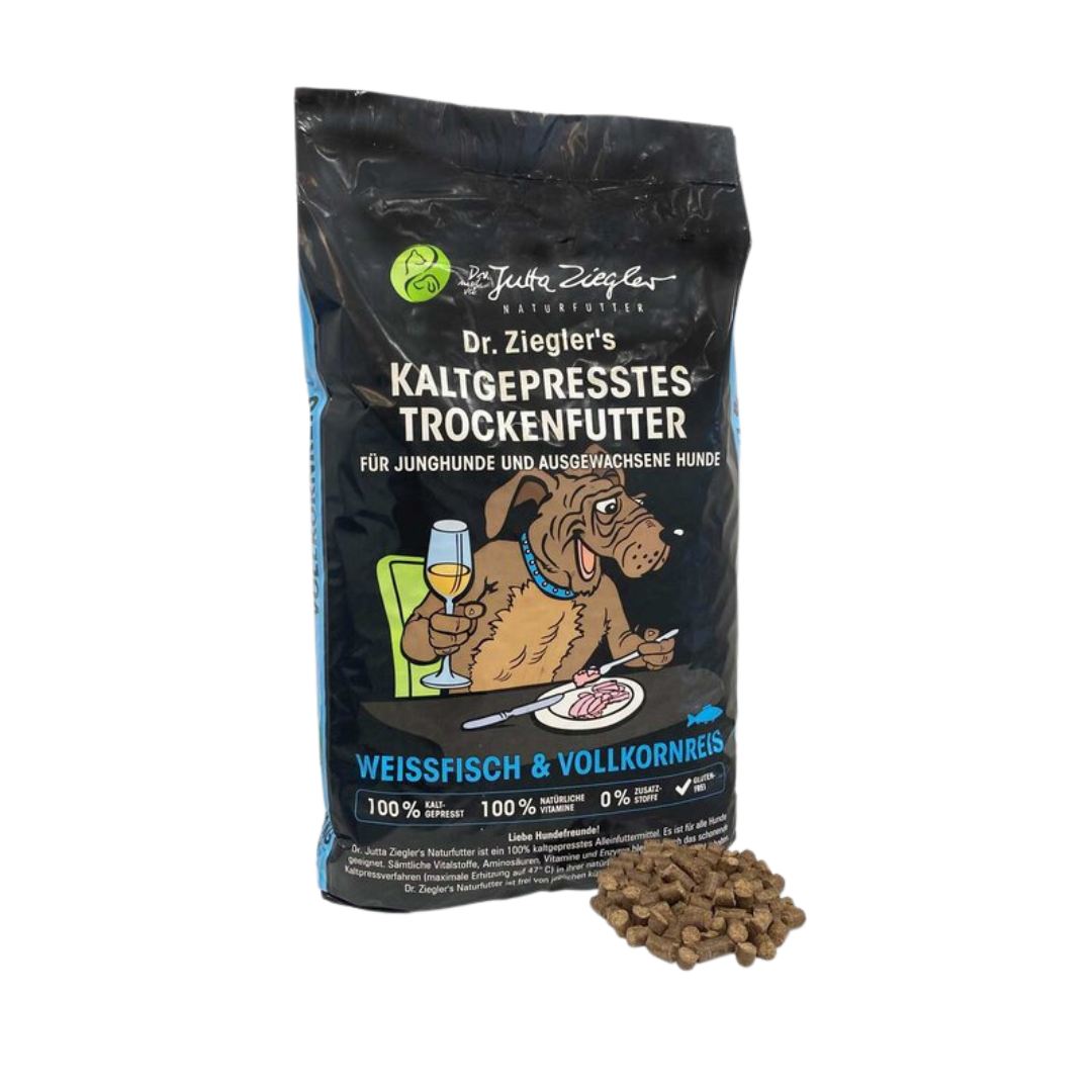 Schwarze Verpackung von Dr. Ziegler's kaltgepresstem Trockenfutter für Hunde mit Illustration eines Hundes, der an einem Tisch sitzt und Wein trinkt, Text 'Weissfisch & Vollkornreis' und Futterstückchen daneben.