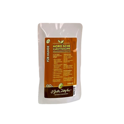 Verpackung von 'Moro'sche Karottensuppe für Hunde', 130 g. Braune Vorderseite mit grünen und weißen Elementen, Zutatenliste und Herstellerinformationen.