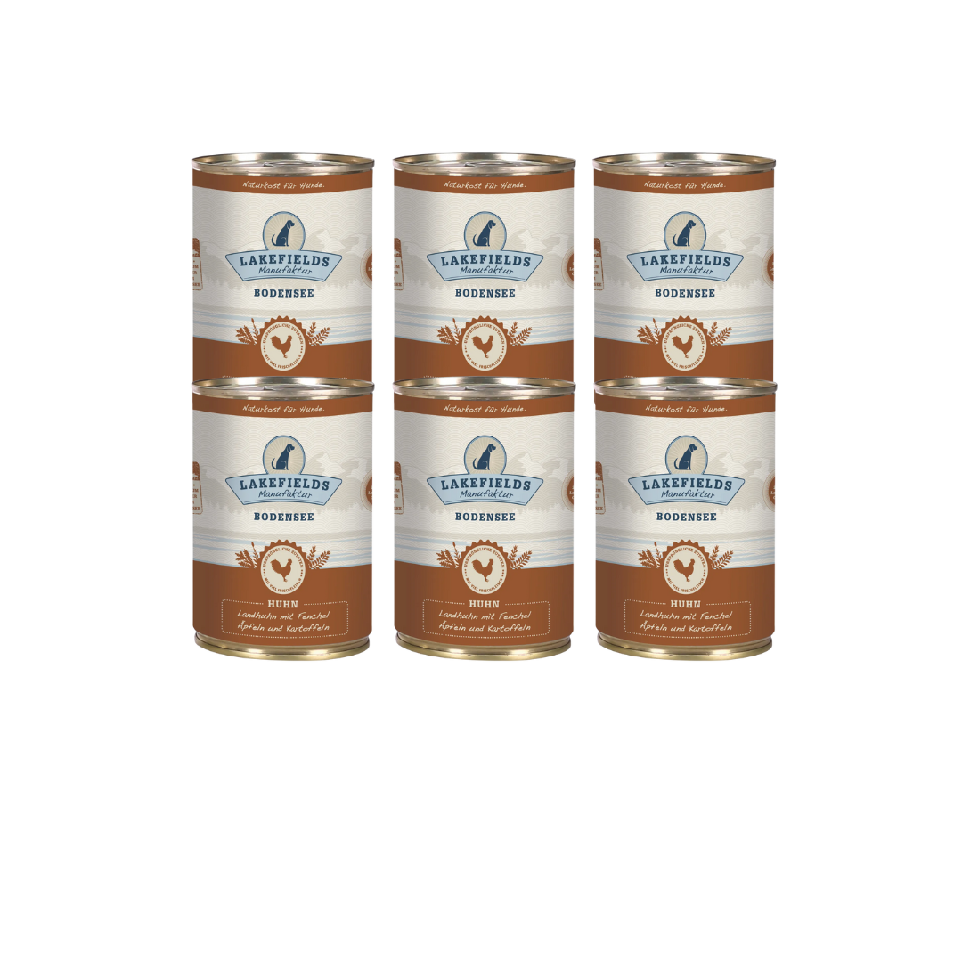 Sechs Runde Dosen mit dem Etikett 'LAKEFIELDS', Inhalt: Landhuhn mit Fenchel, Äpfeln und Kartoffeln. Die Dose hat einen metallischen Glanz und eine braune Farbfläche.