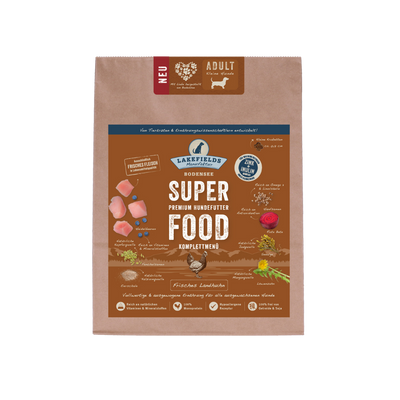 Verpackung von Lakefields Superfood für Hunde, 1 kg. Braune Tüte mit Bildern von Landhuhn, Kräutern und dem Text 'NEU' und 'MINI Adult'.