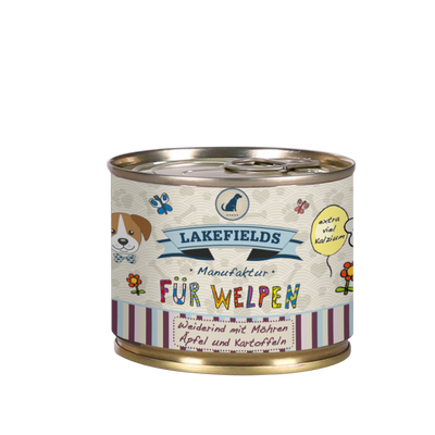 Runde Dose mit Hundefutter von Lakefields, 200g. Auf dem Etikett steht 'BODENSEE FÜR WELPEN', mit Abbildungen von Hunden, Blumen und Texten.
