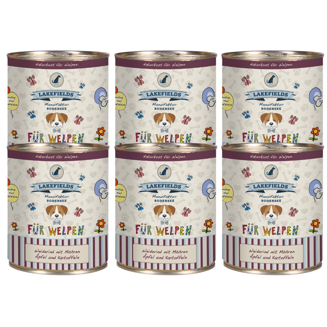 Sechs runde Dosen mit Hundefutter von Lakefields, 800g. Auf dem Etikett steht 'BODENSEE FÜR WELPEN', mit Abbildungen von Hunden, Blumen und Texten.