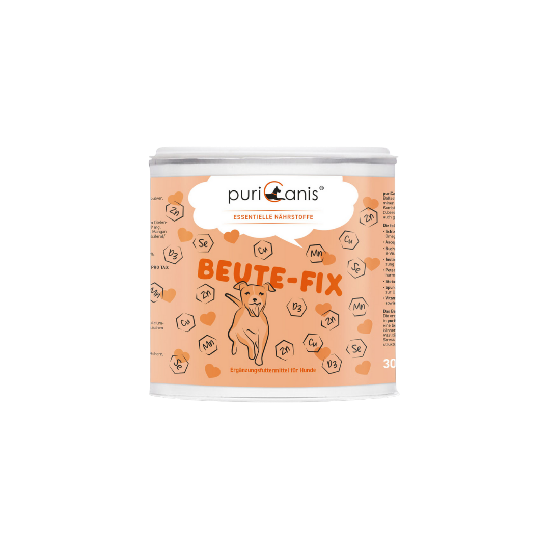 Runde Dose mit Aufschrift 'puriCanis ESSENTIELLE NÄHRSTOFFE BEUTE-FIX' und Illustration eines sitzenden Hundes auf orangefarbenem Hintergrund