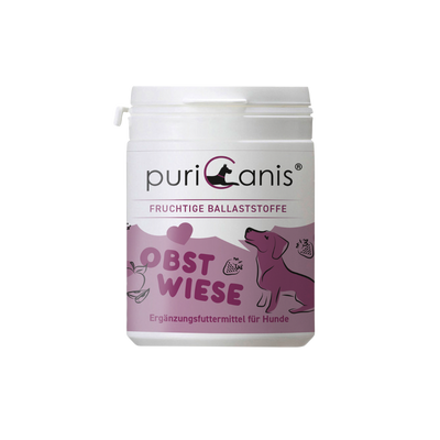 Weißer Behälter mit Aufschrift 'puriCanis', darunter 'Fruchtige Ballaststoffe', 'Obstwiese' und 'Ergänzungsfuttermittel für Hunde', mit lila Hund und Früchten als Grafik.