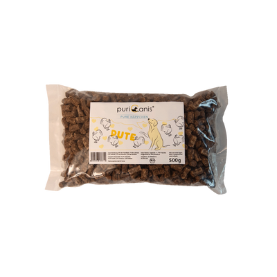 puriCanis Pure Häppchen Pute, 500g Packung mit braunen, rechteckigen Hundeleckerlis, auf der Verpackung Zeichnungen von Hühnern und einem Hund.