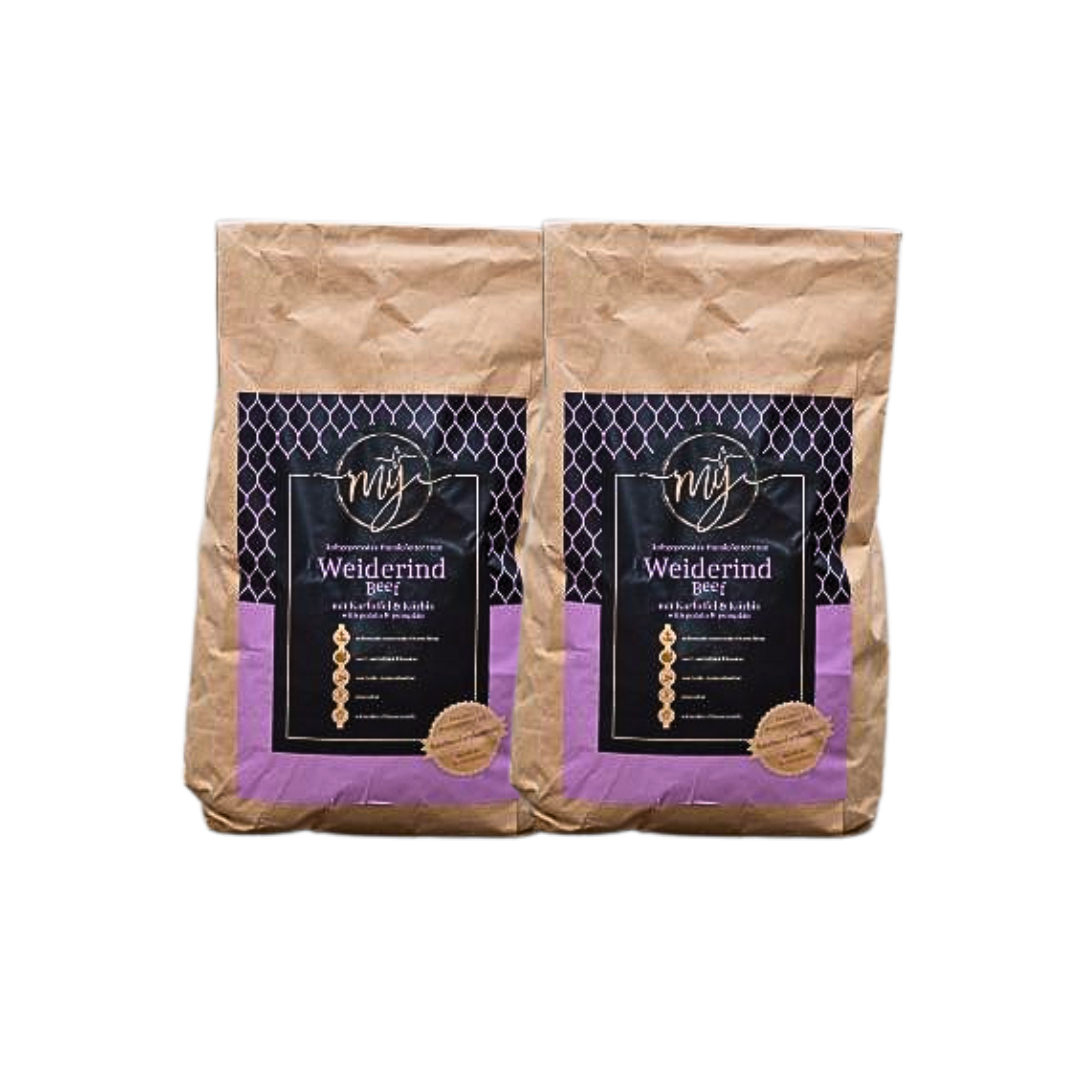 Zwei braune Papiertüten mit violetten Etiketten, beschriftet mit 'mysignature Weiderind, Beef jeweils mit goldfarbenem Siegelaufkleber.