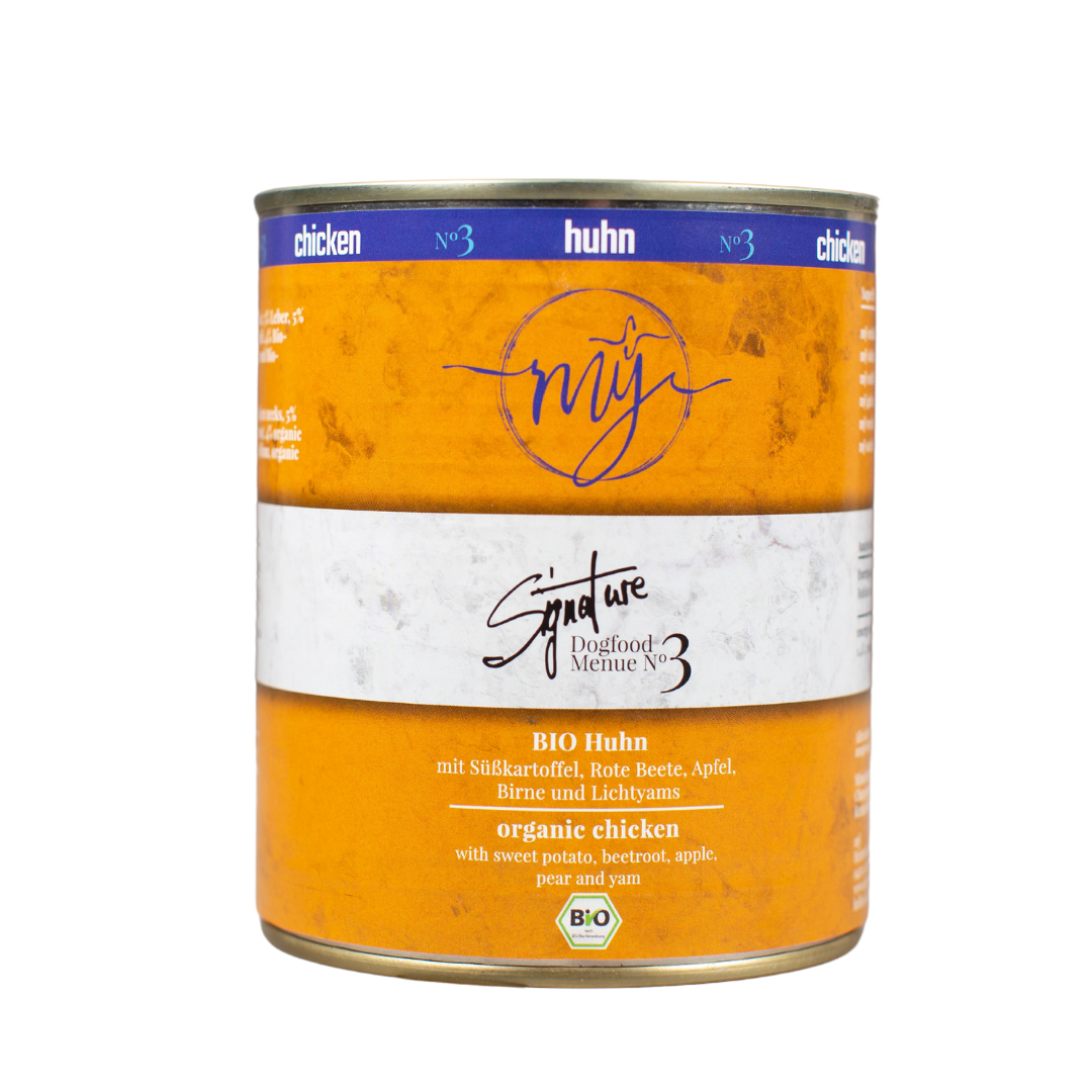 Dose Hundefutter mit gelben Etikett. Aufschrift: my Signature, Dogfood Menue No. 3, BIO Huhn und Zutaten wie Süßkartoffel, Rote Beete, Äpfel, Birne.