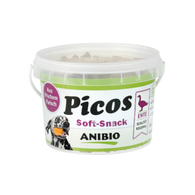 Dose mit Deckel, beschriftet mit 'Picos Soft-Snack', Marke 'ANIBIO', enthält Entenfleisch, abgebildet mit einem Hund und einem Entensymbol.