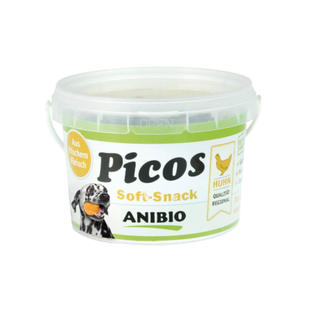 Dose mit Deckel, beschriftet mit 'Picos Soft-Snack', Marke 'ANIBIO', enthält Hühnerfleisch, abgebildet mit einem Hund und einem Huhnsymbol.