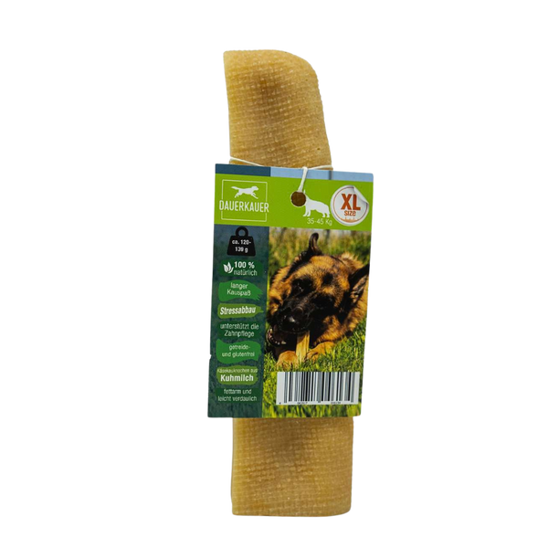 Gelber Hundekauartikel mit einer grünen Verpackung. Auf der Verpackung ist ein Hund mit einem Kauknochen abgebildet - Size XL. Sichtbarer Barcode.