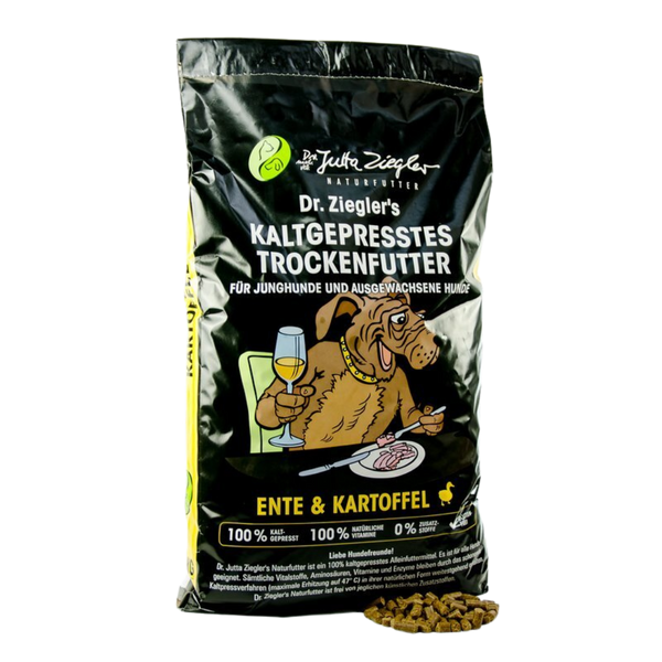 Schwarze Verpackung mit dem Text 'Dr. Ziegler's KALTGEPRRESSES TROCKENFUTTER FÜR JUNGHUNDE UND AUSGEWACHSENE HUNDE' und einem Hund, der ein Glas hält. Enthält Trockenfutter aus Ente und Kartoffeln.