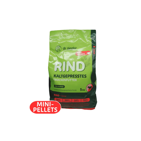 Grün-schwarze Verpackung von dr. ziegler mit der Aufschrift 'RIND KALTGEPRESSTES TROCKENFUTTER' für Hunde, 5 kg, mit rotem Aufkleber 'MINI-PELLETS'.