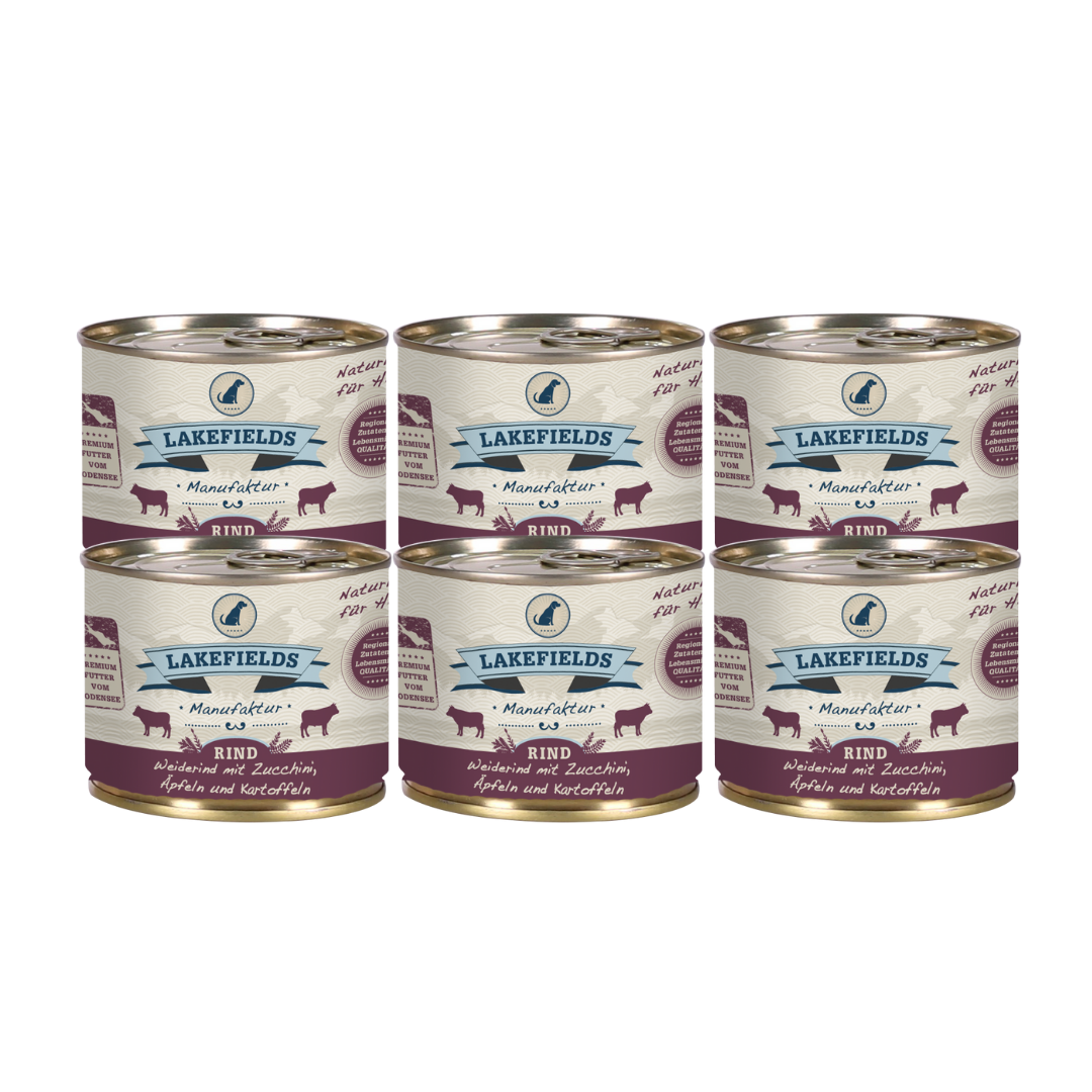 Sechs Runde Dosen mit dem Etikett 'LAKEFIELDS', Inhalt: Weiderind mit Zucchini, Äpfelnund Kartoffeln. Die Dose hat einen metallischen Glanz und violetter Farbfläche.