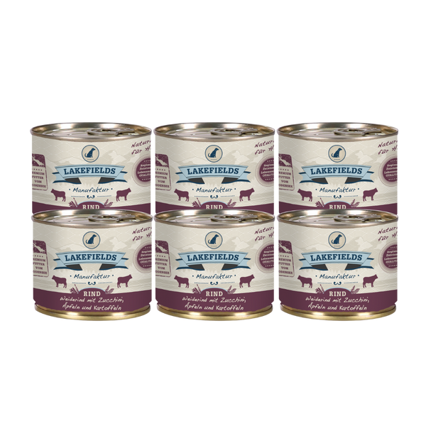 Sechs Runde Dosen mit dem Etikett 'LAKEFIELDS', Inhalt: Weiderind mit Zucchini, Äpfelnund Kartoffeln. Die Dose hat einen metallischen Glanz und violetter Farbfläche.