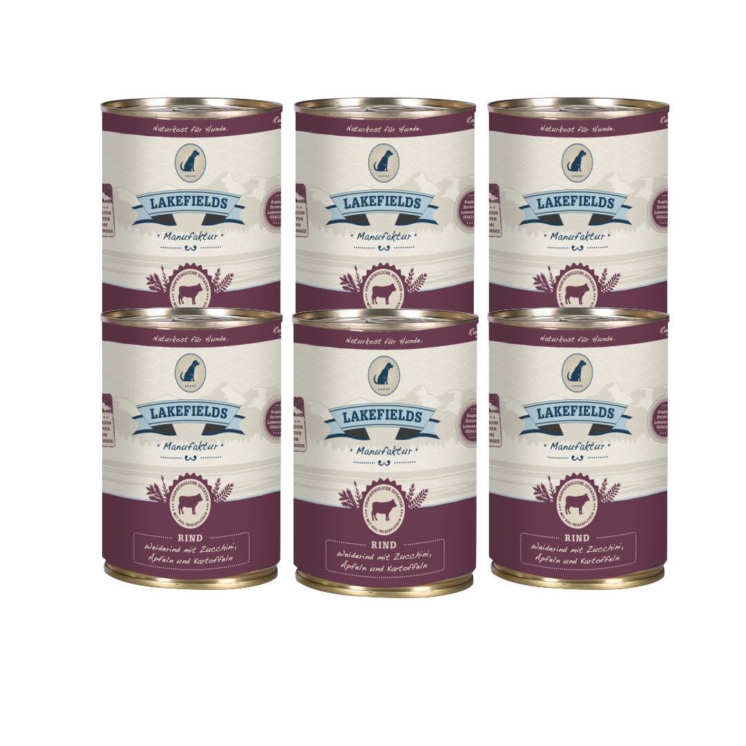 Sechs Runde Dosen mit dem Etikett 'LAKEFIELDS', Inhalt: Weiderind mit Zucchini, Äpfelnund Kartoffeln. Die Dose hat einen metallischen Glanz und violetter Farbfläche.