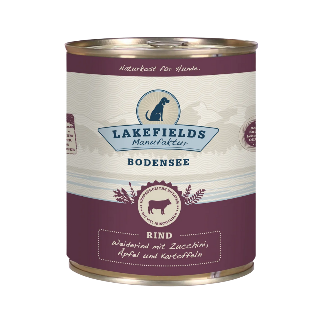 Runde Dose mit dem Etikett 'LAKEFIELDS', Inhalt: Weiderind mit Zucchini, Äpfelnund Kartoffeln. Die Dose hat einen metallischen Glanz und violetter Farbfläche.