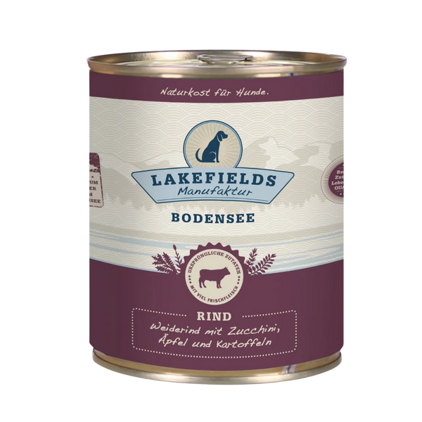 Runde Dose mit dem Etikett 'LAKEFIELDS', Inhalt: Weiderind mit Zucchini, Äpfelnund Kartoffeln. Die Dose hat einen metallischen Glanz und violetter Farbfläche.