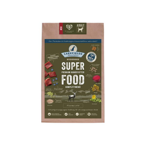 Verpackung von Lakefields Superfood für Hunde, 1 kg. Grüne Tüte mit Bildern von Wild, Kräutern und dem Text 'ADULT'.