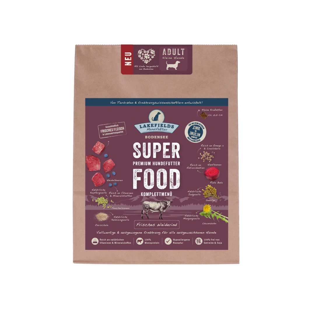 Verpackung von Lakefields Superfood für Hunde, 1 kg. Violette Tüte mit Bildern von Weiderind, Kräutern und dem Text 'NEU' und 'MINI Adult'.