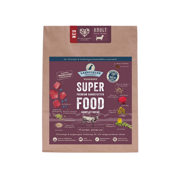 Verpackung von Lakefields Superfood für Hunde, 1 kg. Violette Tüte mit Bildern von Weiderind, Kräutern und dem Text 'NEU' und 'MINI Adult'.