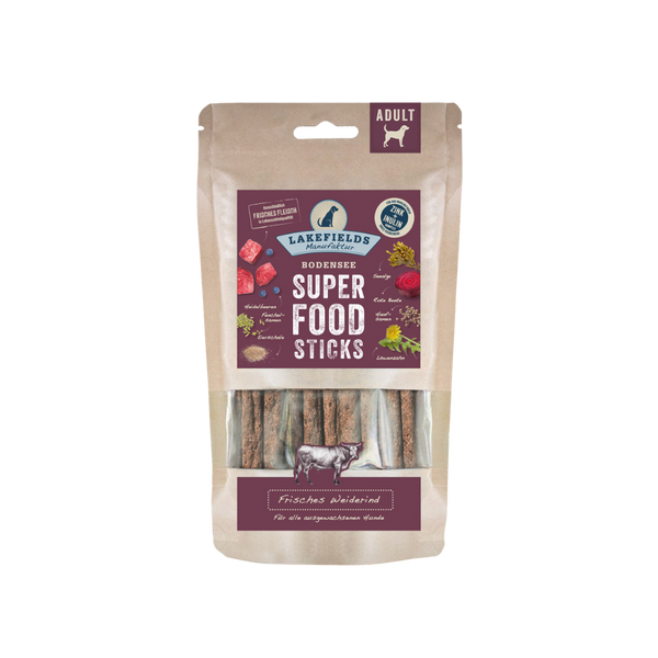 Verpackung von Lakefields Superfood Sticks, 130g. Die Tüte zeigt verschiedene Zutaten wie Gemüse und Fleisch, mit einem Hundesymbol.