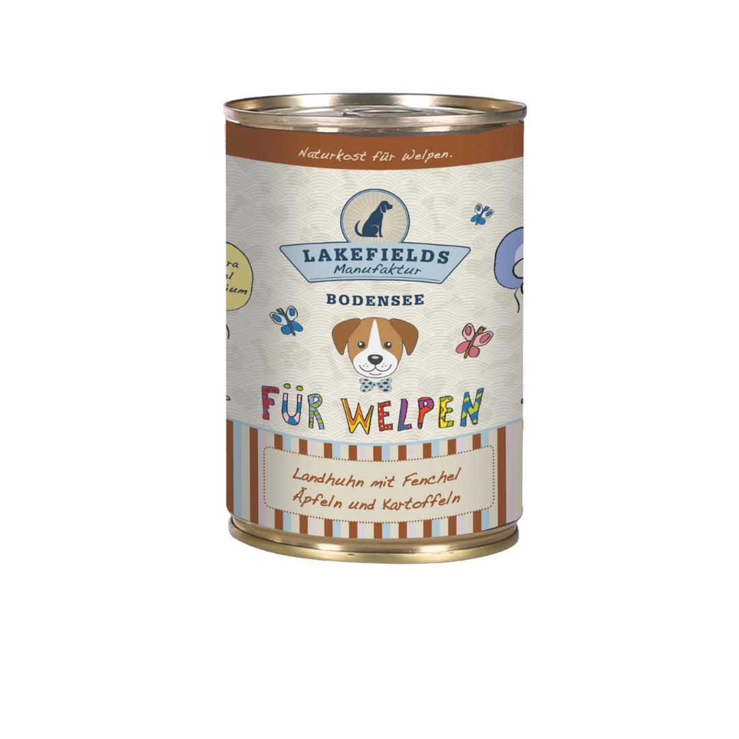 Runde Dose mit Hundefutter von Lakefields, 400g. Auf dem Etikett steht 'BODENSEE FÜR WELPEN', mit Abbildungen von Hunden, Blumen und Texten.
