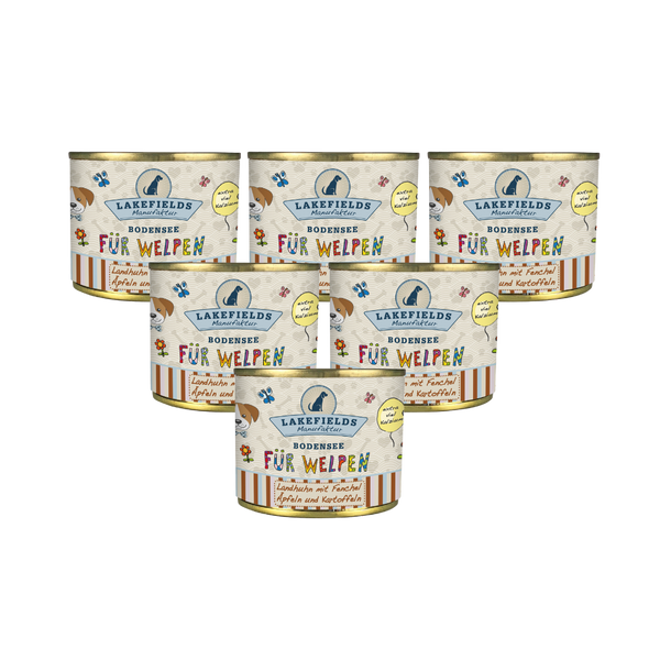 Sechs runde Dosen mit Hundefutter von Lakefields, 200g. Auf dem Etikett steht 'BODENSEE FÜR WELPEN', mit Abbildungen von Hunden, Blumen und Texten.