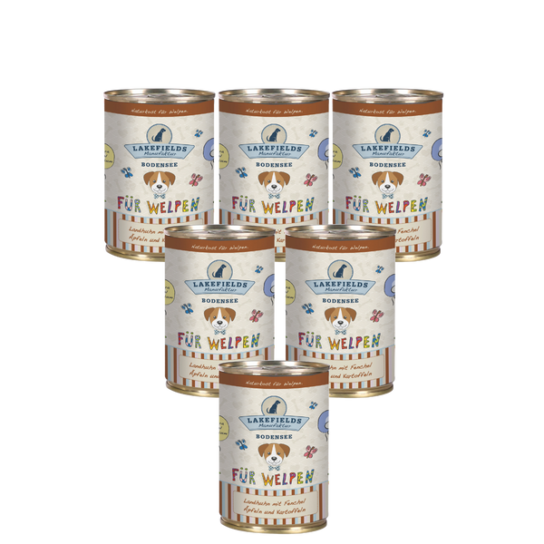 Sechs runde Dosen mit Hundefutter von Lakefields, 400g. Auf dem Etikett steht 'BODENSEE FÜR WELPEN', mit Abbildungen von Hunden, Blumen und Texten.