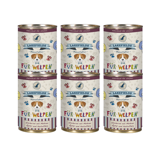 Sechs runde Dosen mit Hundefutter von Lakefields, 400g. Auf dem Etikett steht 'BODENSEE FÜR WELPEN', mit Abbildungen von Hunden, Blumen und Texten.