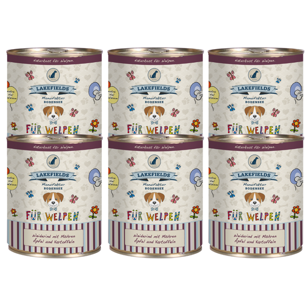 Sechs runde Dosen mit Hundefutter von Lakefields, 800g. Auf dem Etikett steht 'BODENSEE FÜR WELPEN', mit Abbildungen von Hunden, Blumen und Texten.