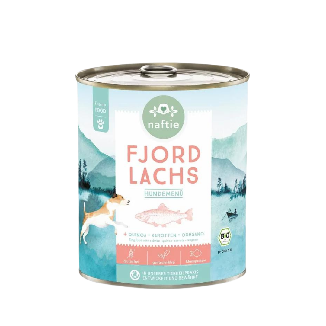 Runddose mit dem Produktnamen 'FJORD LACHS' von naftie. Enthält Quinoa, Karotten und Oregano. Abgebildet sind ein Hund und eine Landschaft mit Bergen und Wasser.