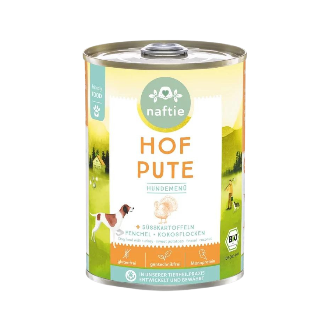 Dose mit Bio-Hundefutter von naftie, 400g, mit Abbildung eines Hundes und Landschaft im Hintergrund. Aufschrift: 'HOF PUTE HUNDEMENÜ.