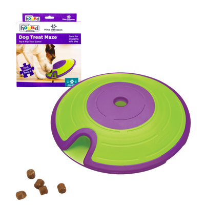 Grün, violetter schalenförmiger Behälter mit Deckel um Futter zu verstecken. Fünf runde Kroketten links. Marke Nina Ottossson-Dog-Traet-Maze