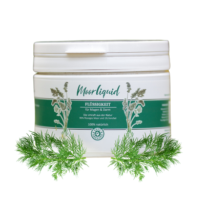 Runddose mit weißem Deckel und grünem Etikett. Auf dem Etikett steht 'Moorliquid FLÜSSIGKEIT für Magen & Darm'. Umgeben von frischen Fenchelblättern.