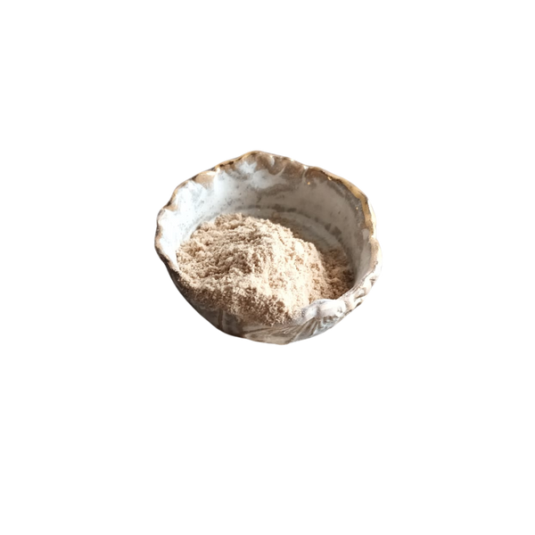 Schale aus Keramik mit unregelmäßigem Rand und goldfarbener Verzierung, gefüllt mit feinem, hellbraunem Pulver.