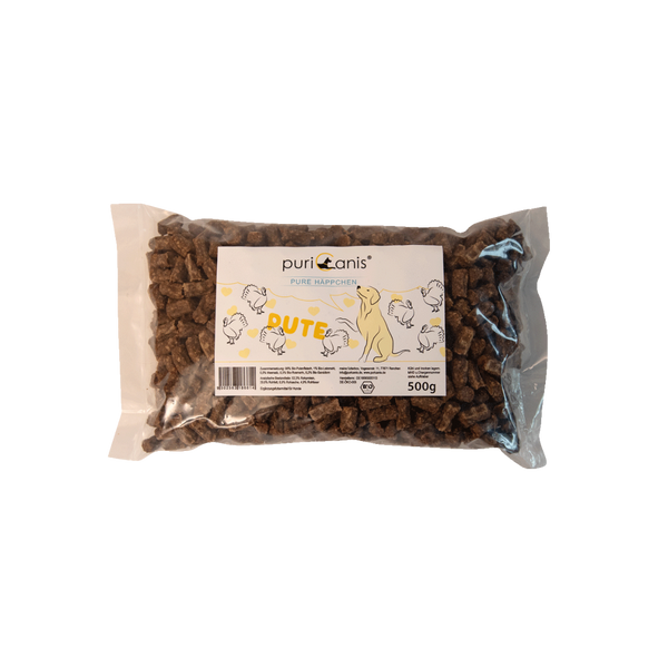 puriCanis Pure Häppchen Pute, 500g Packung mit braunen, rechteckigen Hundeleckerlis, auf der Verpackung Zeichnungen von Hühnern und einem Hund.