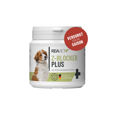 Weißer Behälter mit Aufschrift 'REAVET Z-BLOCKER PLUS mit Schwarzkümmel & Kokos', deutschem Flaggenlogo und rotem Kreis mit Text 'VERSORGT FÜR DIE SAISON'.