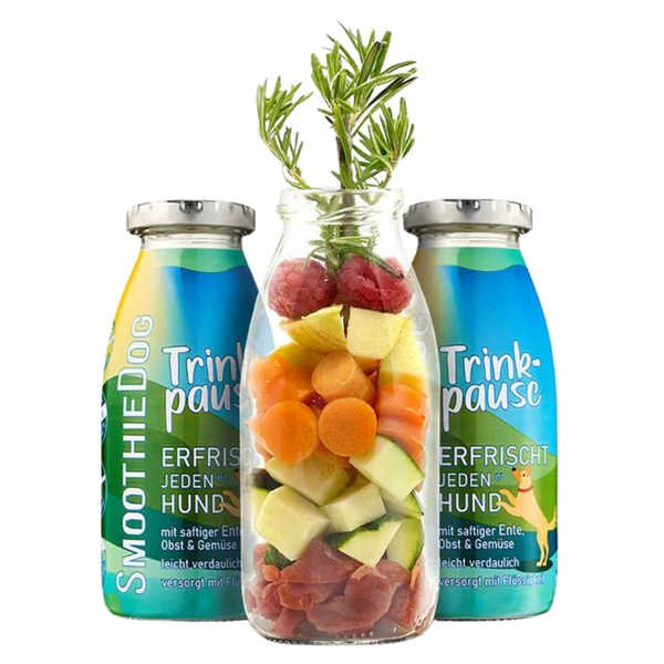Zwei Flaschen SmoothieDog Trinkpause mit Ente, Obst und Gemüse, davor Glasflasche mit geschnittenem Obst, Gemüse, Himbeeren und Rosmarinzweig.