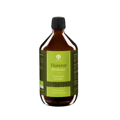 Braunes Glasgefäß mit schwarzem Deckel, grünem Etikett und weißer Schrift, zeigt Produktname 'Floratur Wildkräuter' von Waldkraft, Probiotische Futterergänzung.